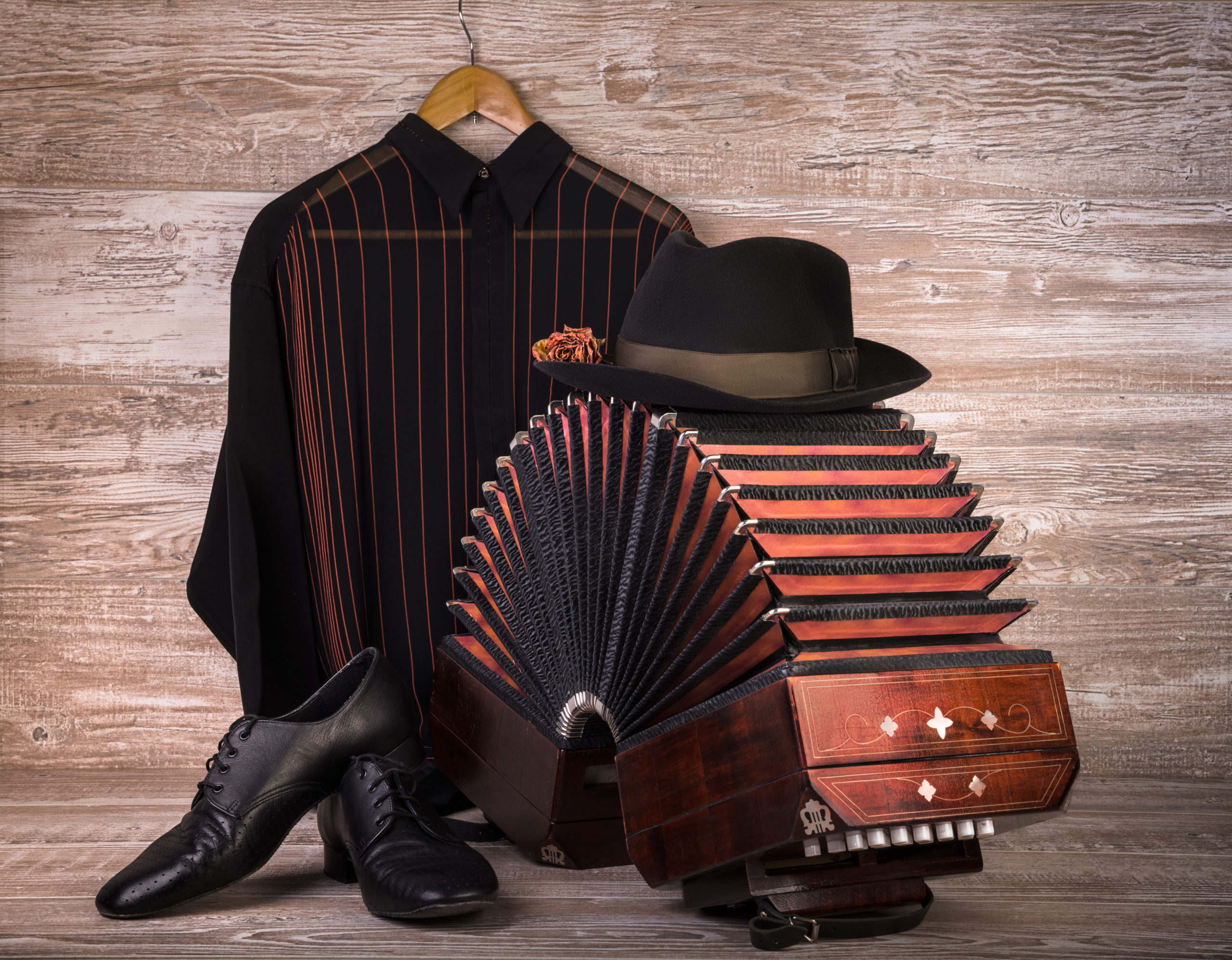 Argentine tango, still life composition with bandoneon on wooden background